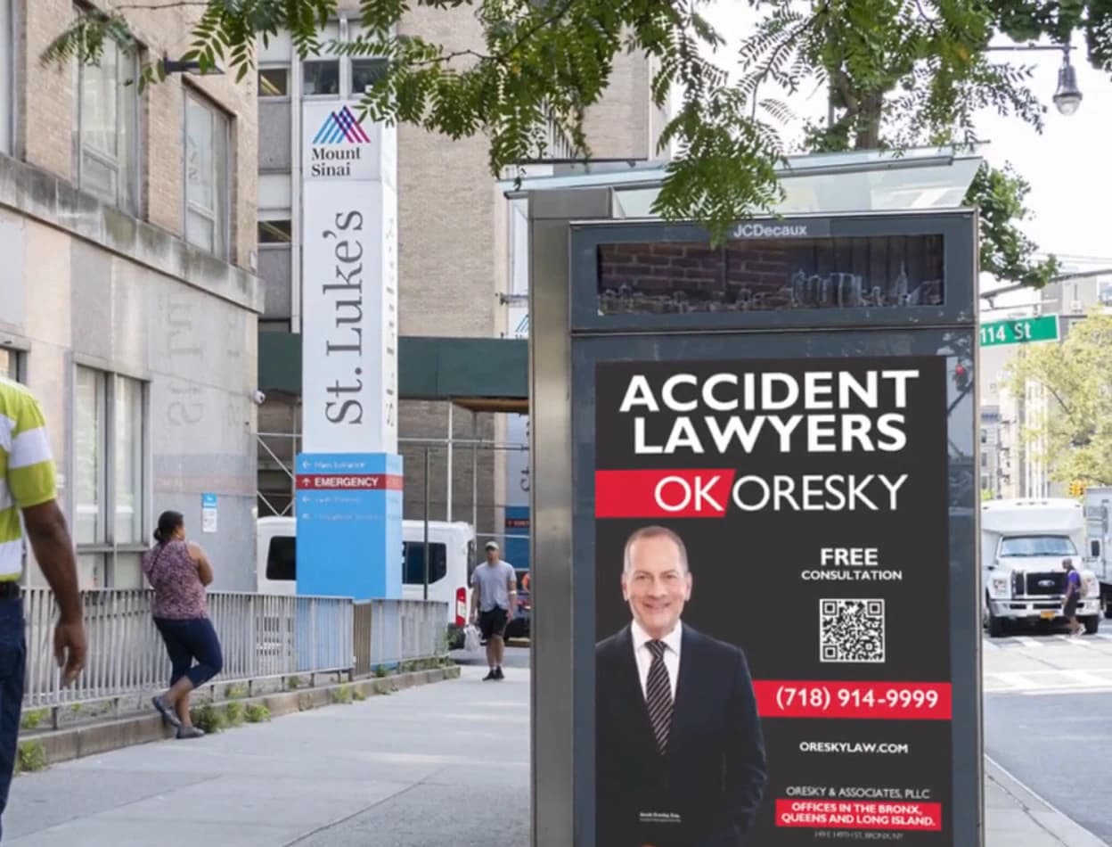 Law firm advertisement on an NYC bus shelter panel